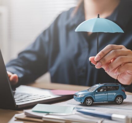 car insurance concept with umbrella and toy vehicl 2026 01 08 08 12 24 utc