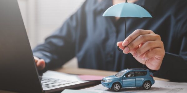 car insurance concept with umbrella and toy vehicl 2026 01 08 08 12 24 utc